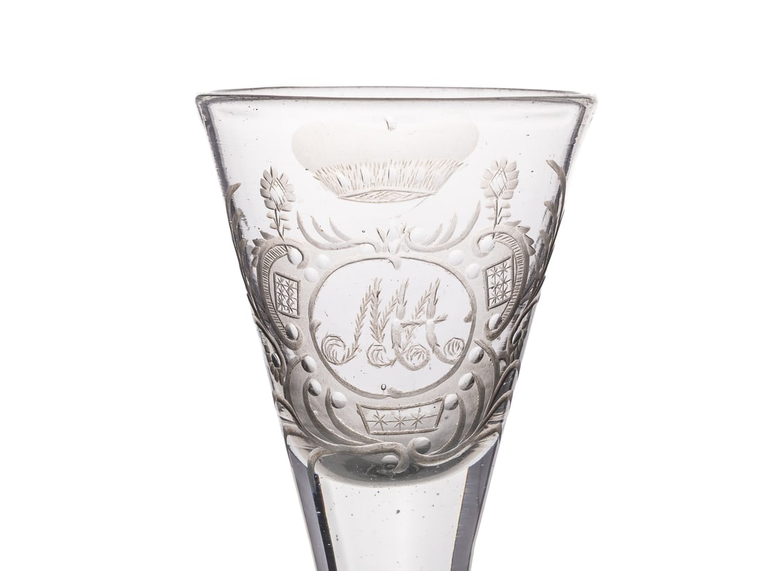Baroque chalice glass, pointed chalice, mid-18th century: Baroque chalice glass, pointed chalice, mid-18th centuryBaroque pointed chalice with coat of arms engraving. The coat of arms features the monogram ‘MA’. Smooth, conical stem on a wide dis