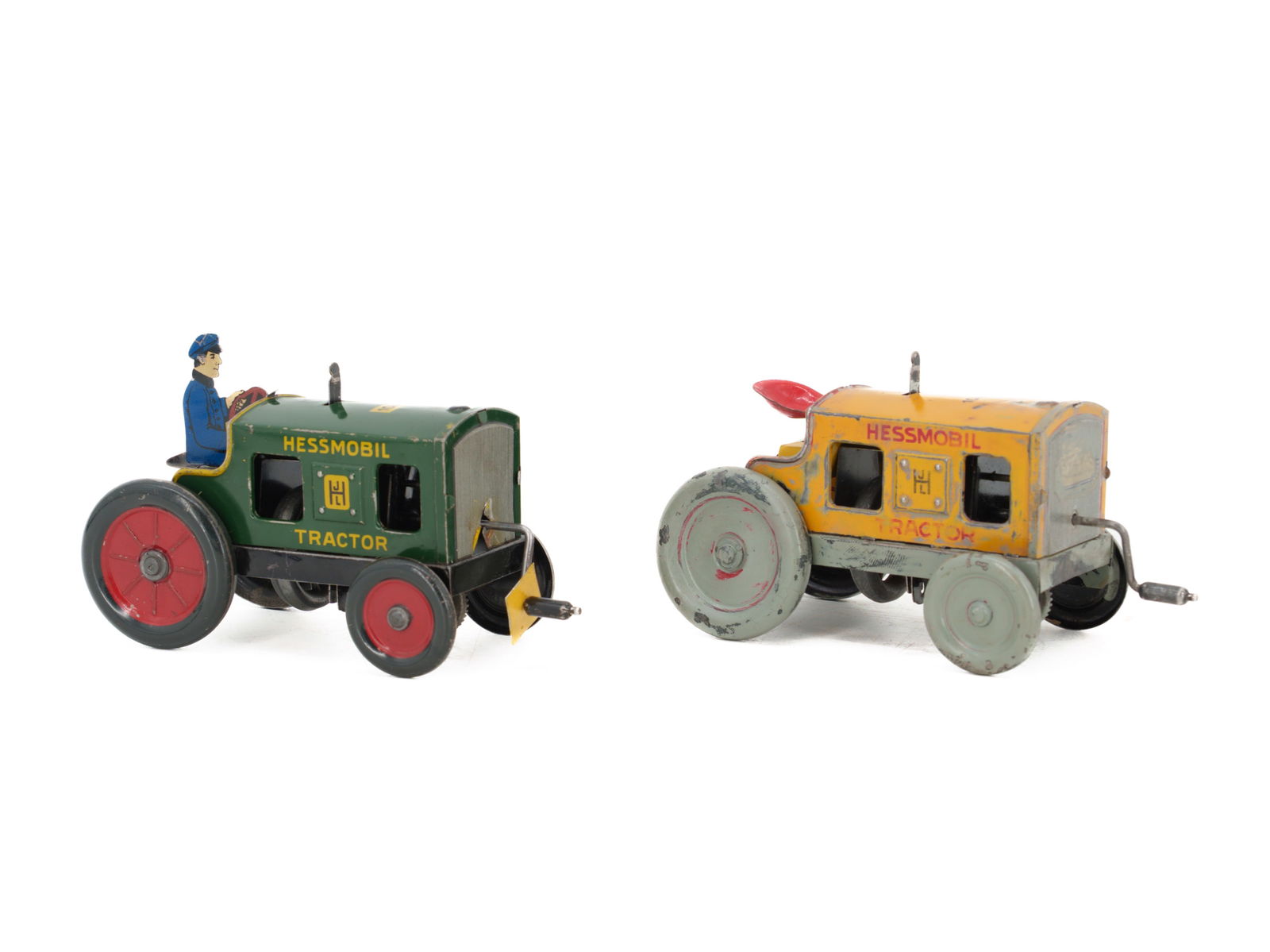 Two Hessmobil 1047 tin tractors, green and yellow, Nuremberg, circa 1930: Two Hessmobil 1047 tin tractors, green and yellow, Nuremberg, circa 1930Two tractors manufactured by Johan Leonard Hess, Hessmobil Tractor 1047: Green with driver. Crank or flywheel drive, non-functio