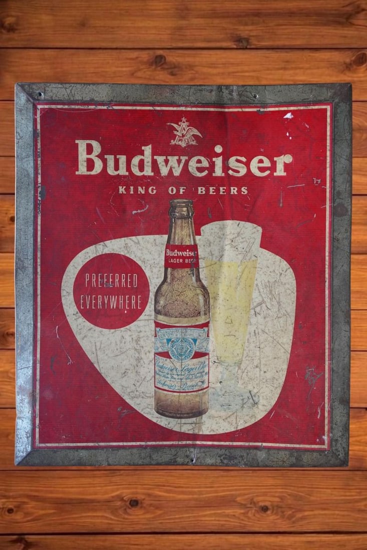 Vintage Budweiser King of Beers Painted Tin Over Cardboard Advertising Sign: A square painted tin over cardboard sign with a Budweiser beer bottle and glass illustration. Text reads 'Budweiser KING OF BEERS'. Shows evenly distributed scuffs across the face with a crease runnin