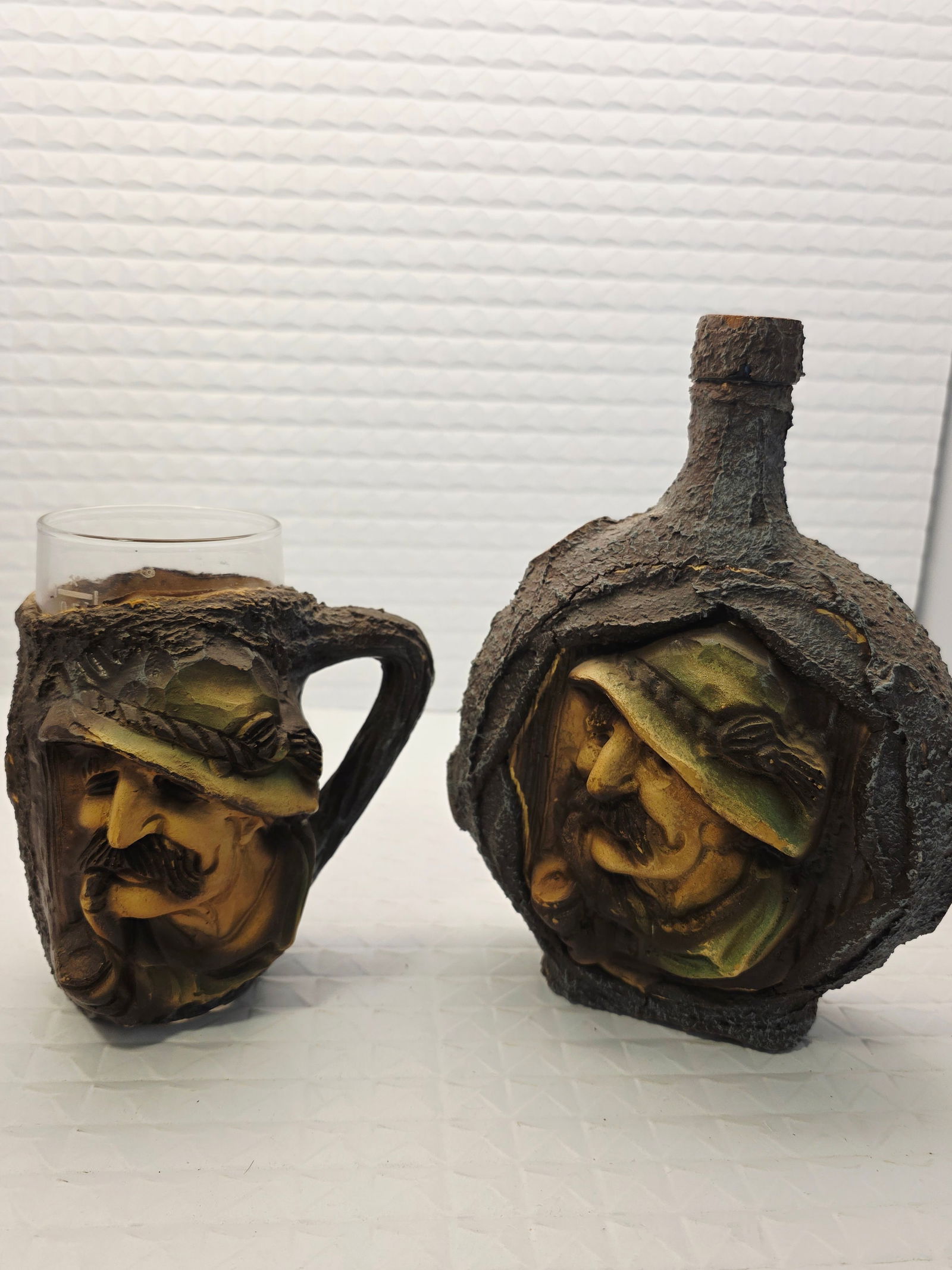 German tree bark bottle with matching glass: This vintage German Deutsches Erzeugnis bottle with matching glass is a must-have for any liquor bottle collector. Encased in tree bark resin, glass bottle and glass cup. With its brown color and uniq