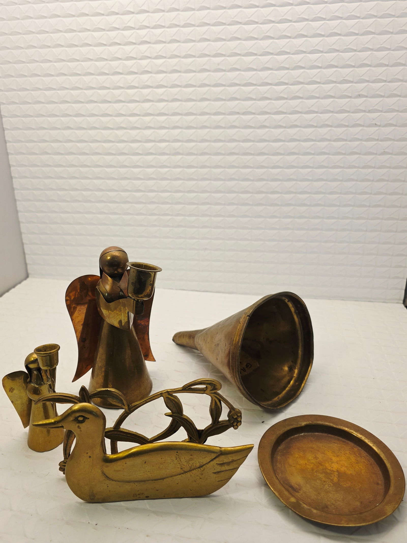 vintage brass and copper collectible decorative pieces: vintage brass and copper collectible decorative pieces, specifically identified as candle holders featuring angel figures and a bird shape. The collection includes various handcrafted angel figures, s