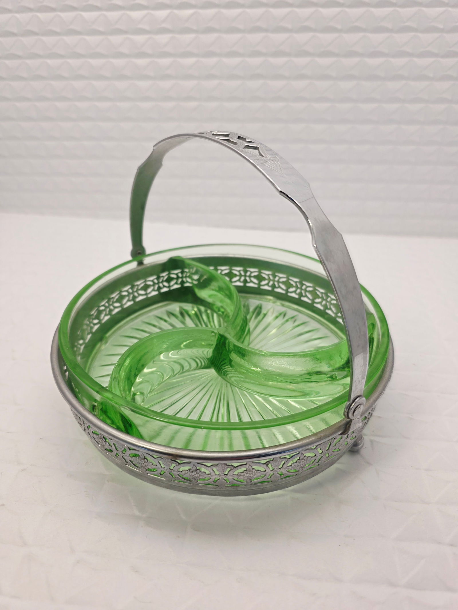 green uranium depression glass divided candy or relish dish: vintage green depression glass divided candy or relish dish, set in a silver colored metal holder with a handle. Material: Green-colored glass, containing uranium, which gives it a distinctive glow un