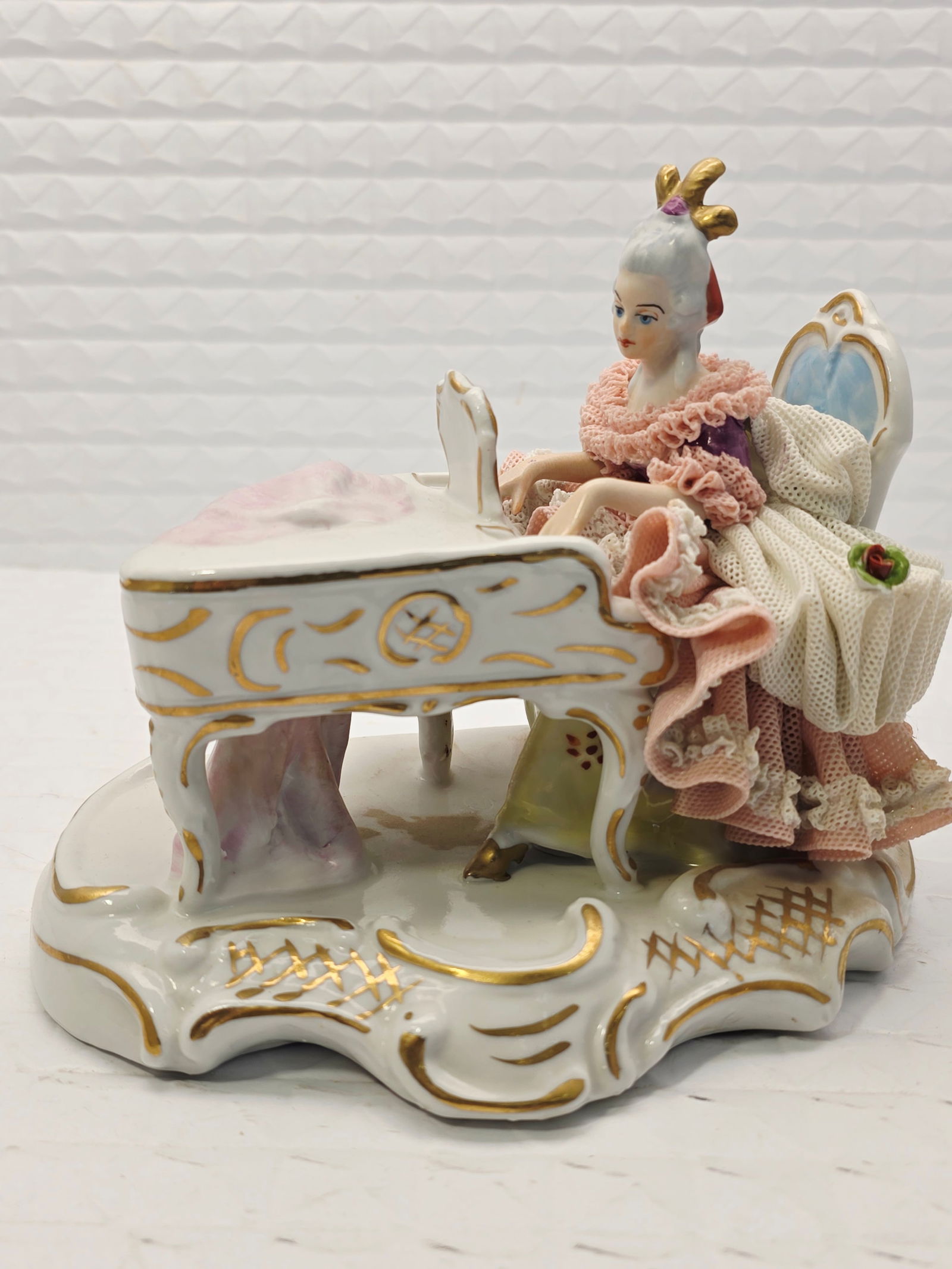 Dresden lace porcelain figurine, lady playing a piano: vintage Dresden lace porcelain figurine made in Germany, depicting a lady playing a piano. Manufacturer: Likely Müller & Co. Volkstedt (Muller-Volkstedt), often associated with Irish Dresden. Style: