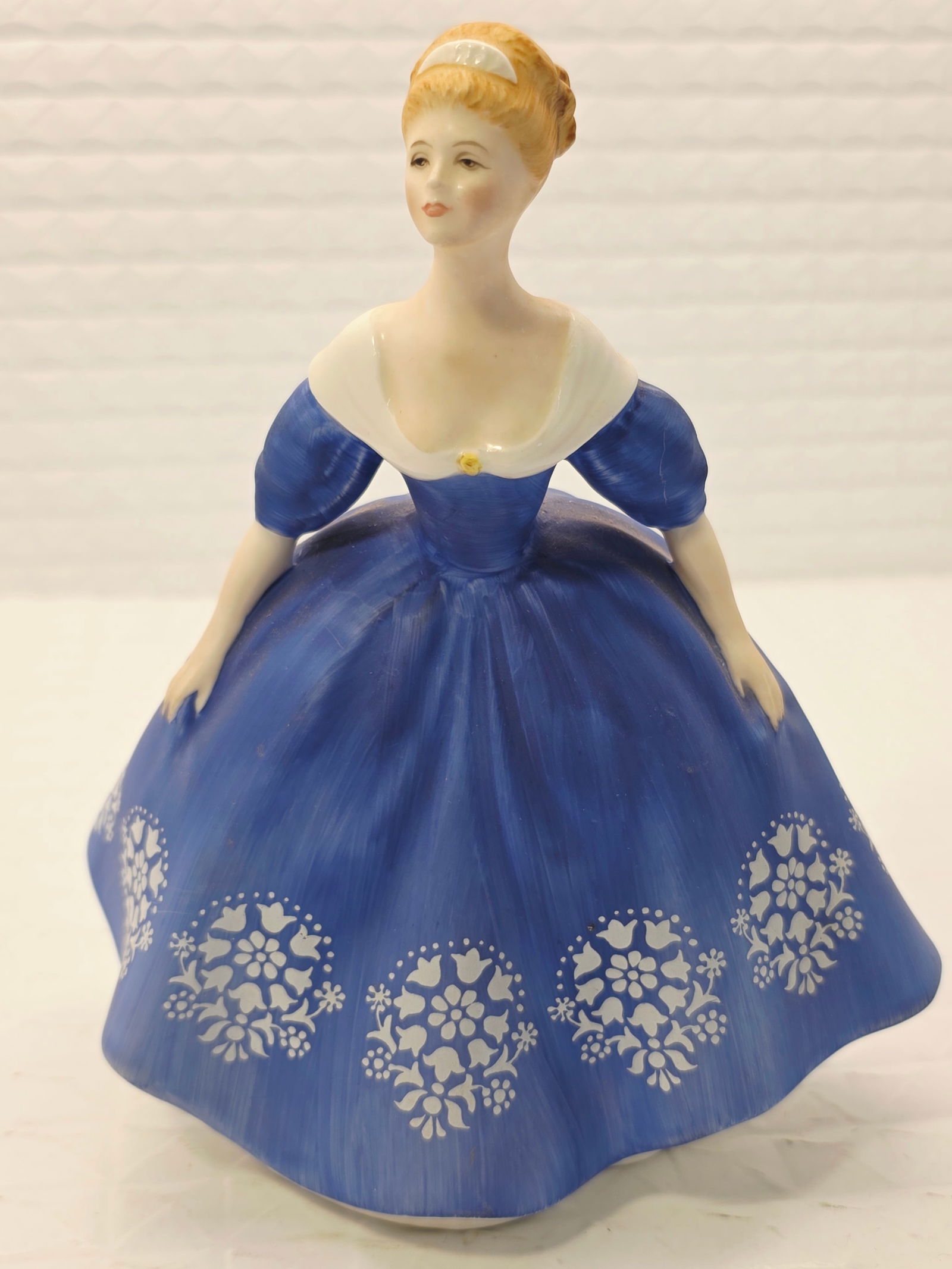 vintage retired Royal Doulton "Nina" figurine (HN2347): vintage Royal Doulton "Nina" figurine (HN2347), first issued in 1969. Designer: Peggy Davies.Finish: Matte.Features: A lady in a blue and white dress with floral details.Status: Retired.While we striv