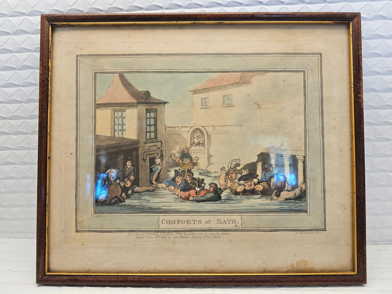 hand-colored etching or antique print titled "Comforts of Bath, Plate 7": hand-colored etching or antique print titled "Comforts of Bath, Plate 7" by the British artist Thomas Rowlandson.Artist and Series: The artwork is part of a satirical series called "The Comforts of Ba