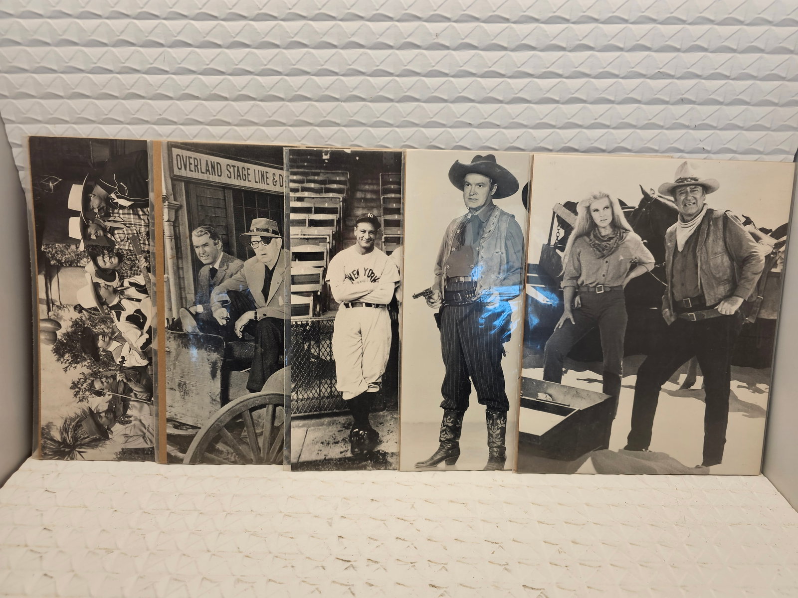 collection of vintage black-and-white promotional photographs from classic Hollywood Western movies: collection of vintage black-and-white promotional photographs from classic Hollywood Western movies.Content: The photos feature various actors and scenes typical of Western films from the 1940s and 19