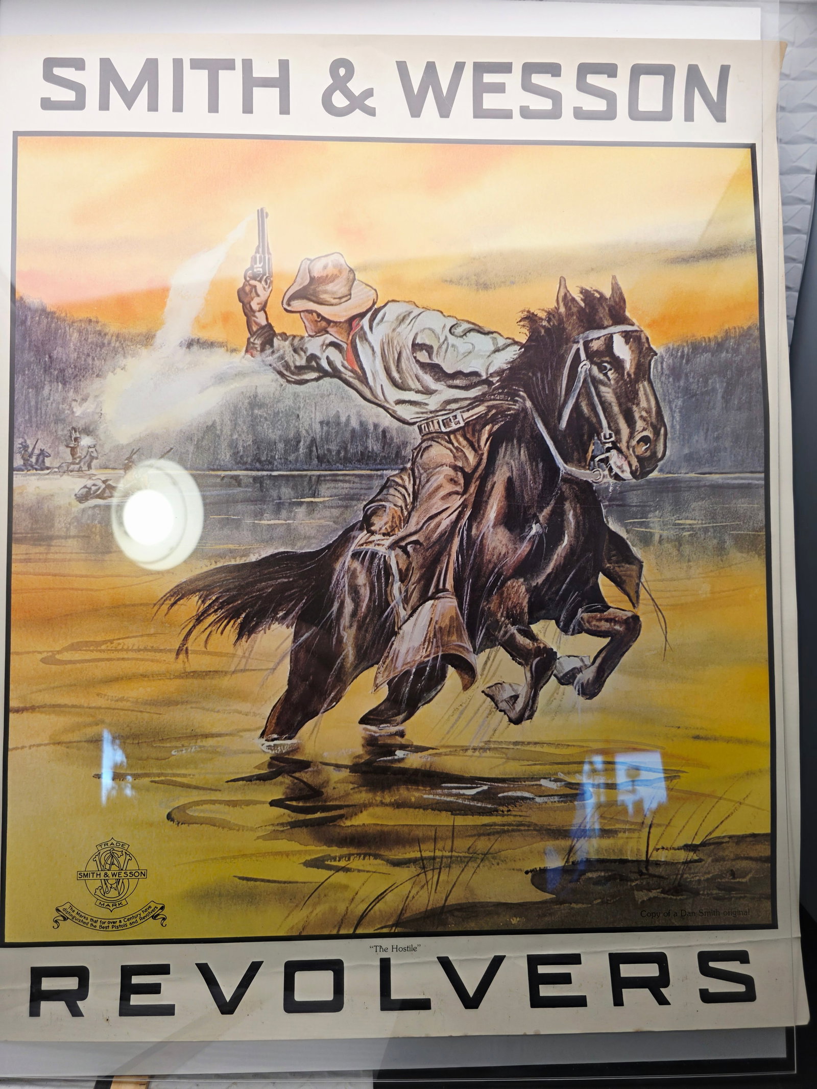 Smith & Wesson advertising poster for "The Hostiles" revolvers: Smith & Wesson advertising poster for "The Hostiles" revolvers featuring a classic Western scene by Dan Smith.Original Artwork: The image is based on a painting by illustrator Dan W. Smith.Historical