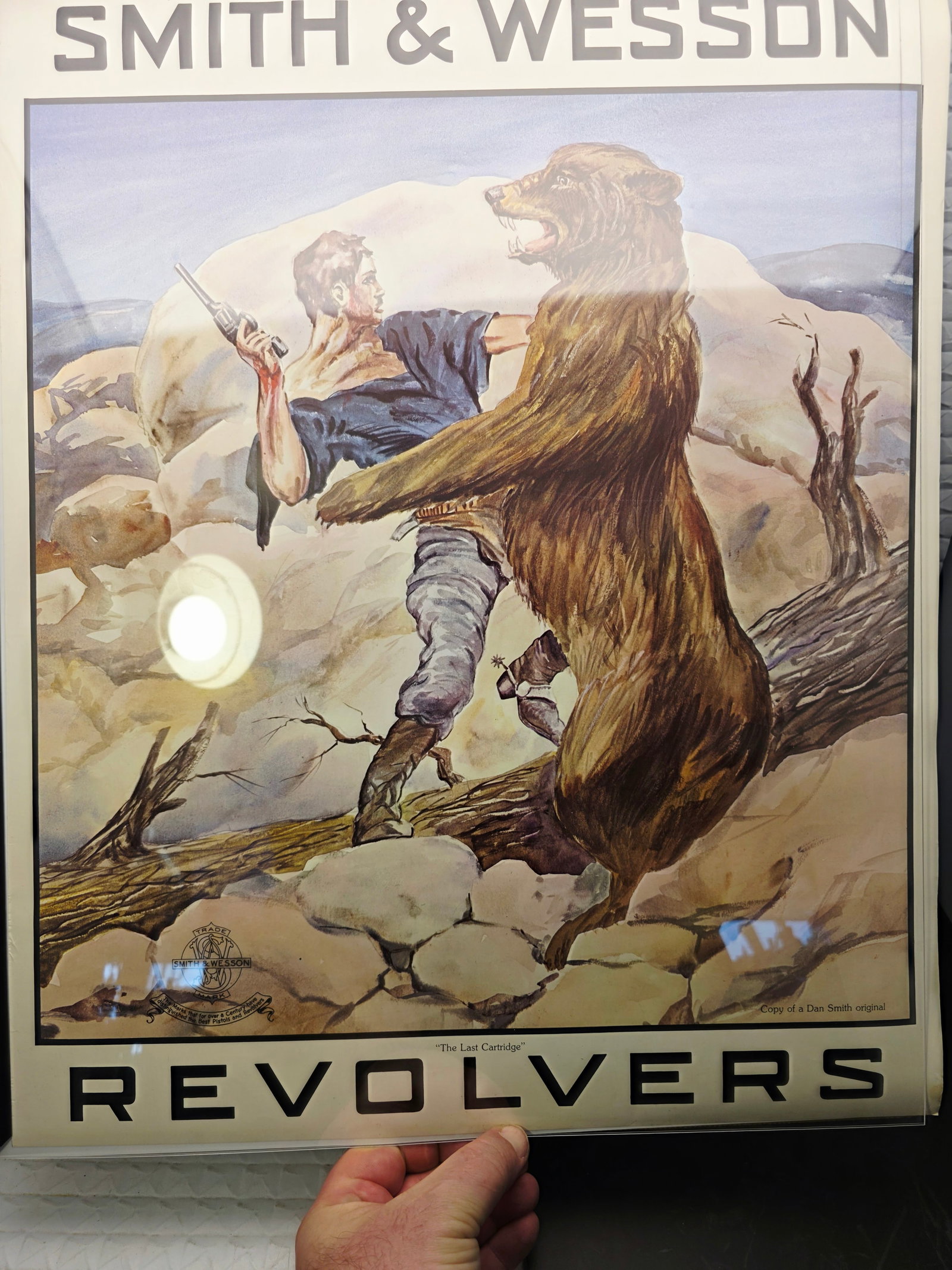 vintage Smith & Wesson advertising poster titled "The Last Cartridge": Smith & Wesson advertising poster titled "The Last Cartridge" featuring a Dan Smith original illustration.Illustration Origin: The original artwork was commissioned by Smith & Wesson from artist Dan