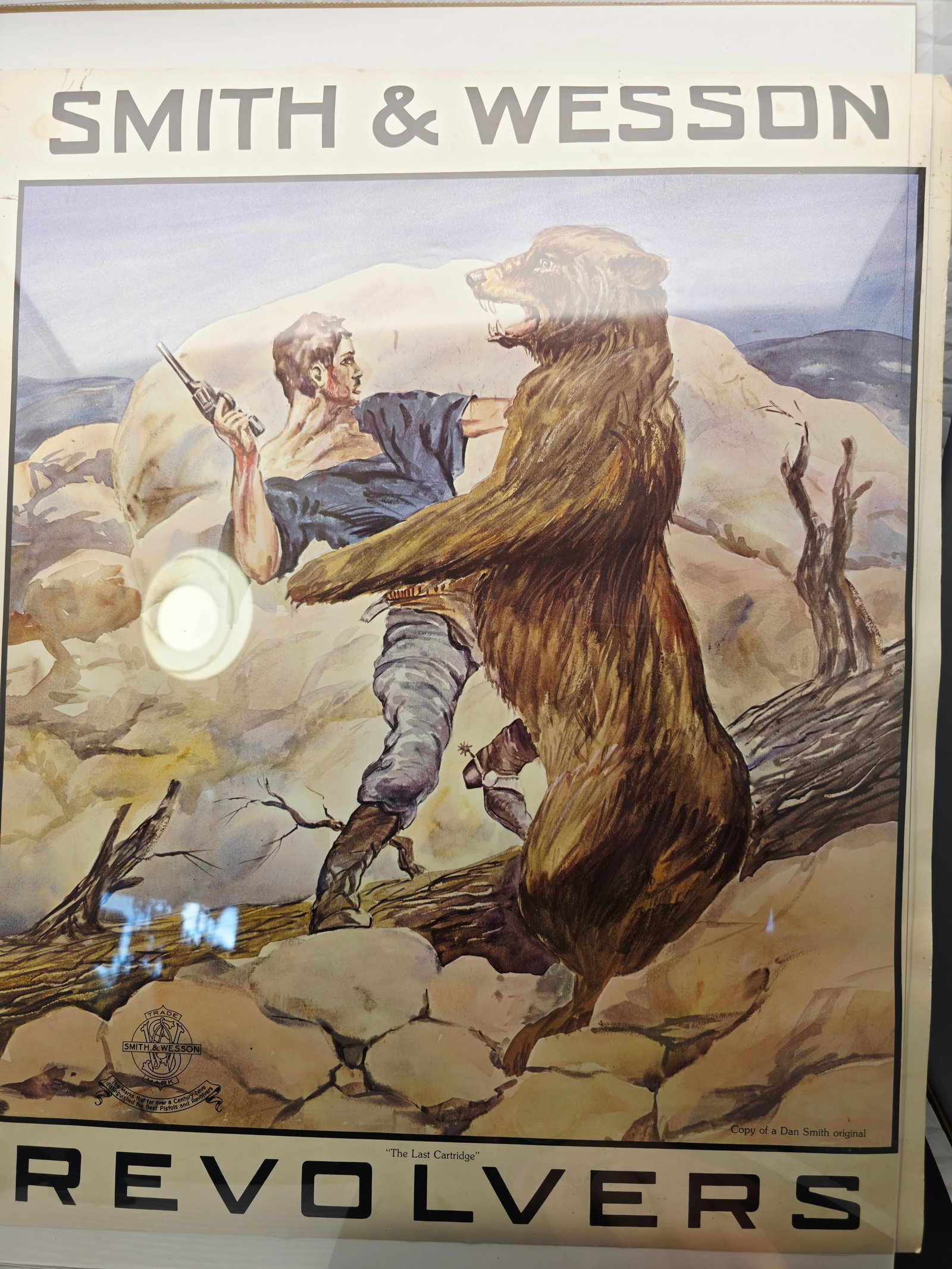 second vintage Smith & Wesson advertising poster titled "The Last Cartridge": Smith & Wesson advertising poster titled "The Last Cartridge" featuring a Dan Smith original illustration.Illustration Origin: The original artwork was commissioned by Smith & Wesson from artist Dan