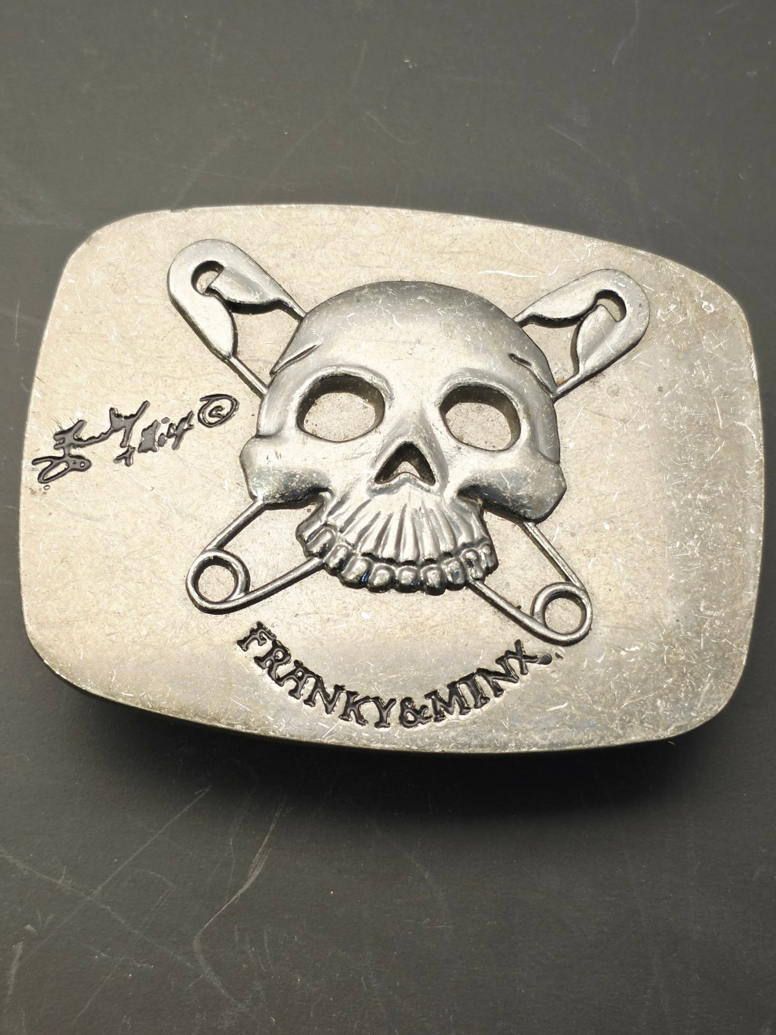 vintage Franky & Minx skull and crossbones belt buckle and storage box: Franky & Minx was an edgy fashion and accessories label prominent during the early to mid-2000s. Original apparel and metal hardware pieces from the line have become highly sought-after vintage punk c