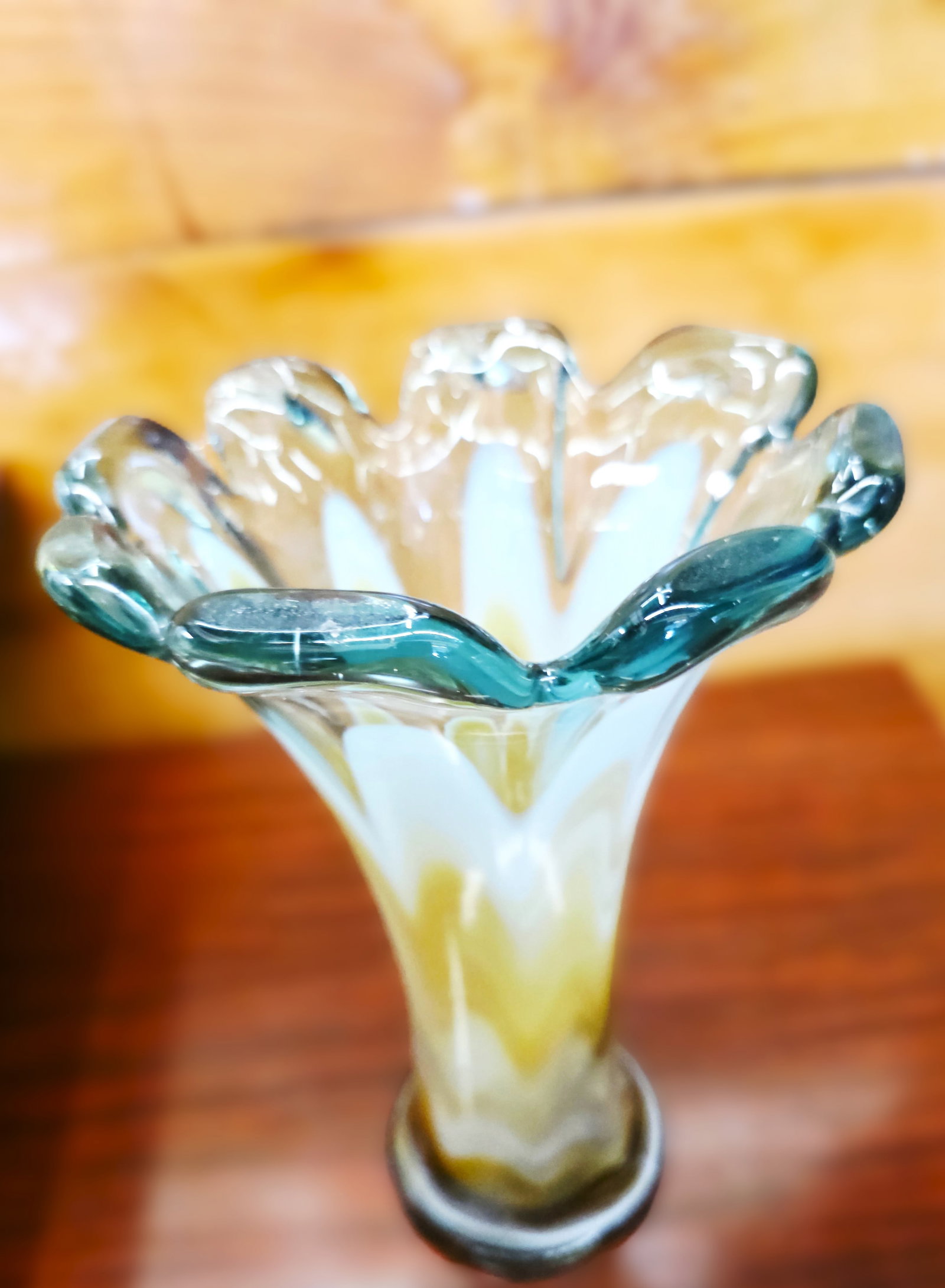 Beautiful vintage Murano glass vase featuring a flared, ruffled rim and a marbleized swirl: Refined Italian tall vase in Murano art glass, 1960s. This vase is characterized by a particular design shape. The vase is of high artistic quality made with the blown glass technique.Characterized by