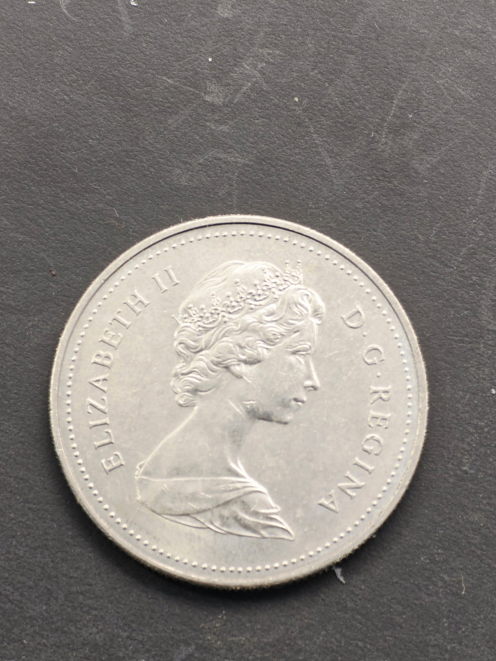 1985 Canadian one-dollar coin, featuring the iconic "Voyage: Not a silver version. Since these coins were found in the hidden, cherished collection of the deceased collector, we are posting them here per the request of the consignor in case they are rare or hav