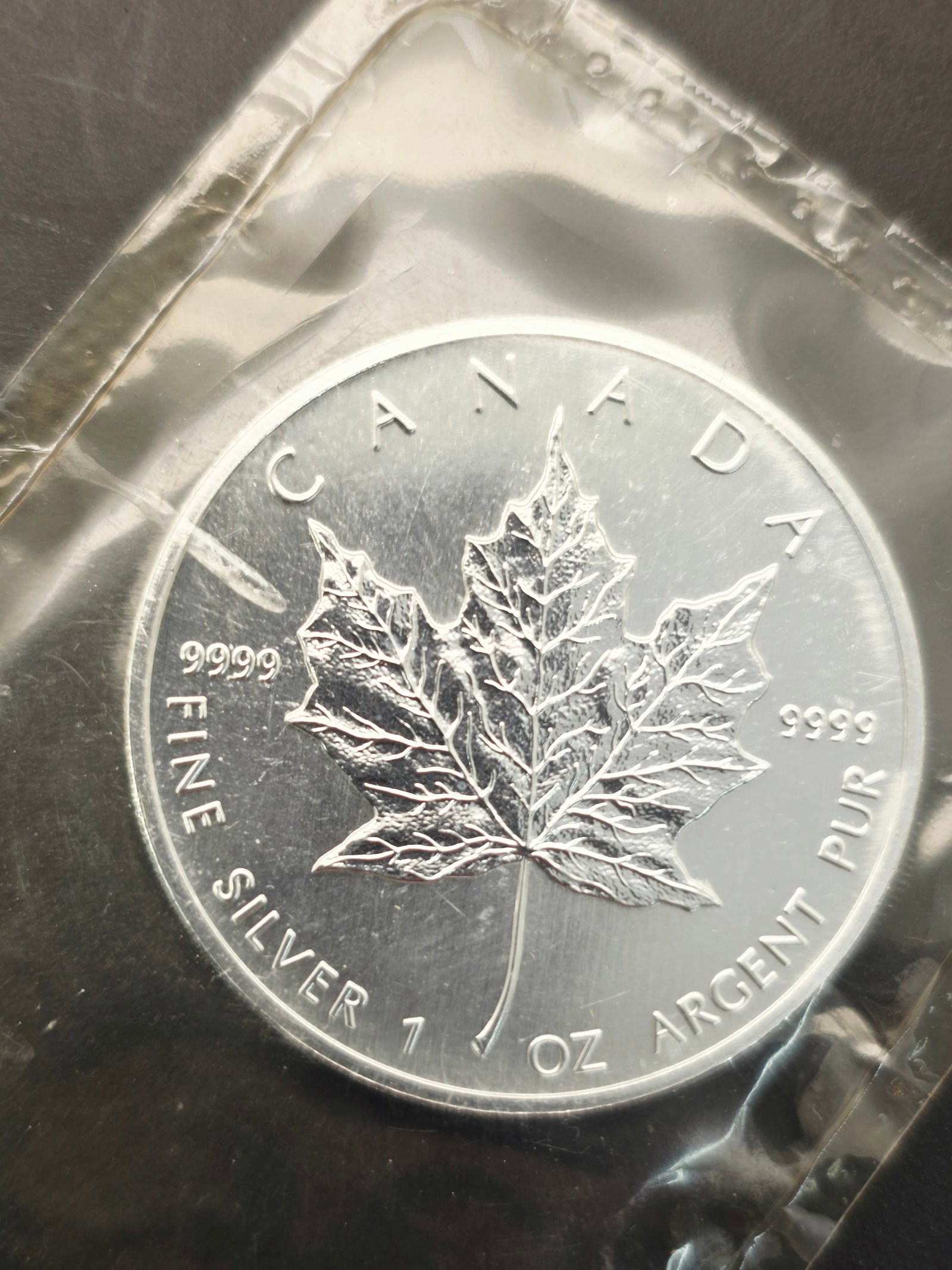 99% Silver 1 oz Canadian Silver Maple Leaf coin: This item is a 1 oz Canadian Silver Maple Leaf coin.Purity: The coin is struck from .9999 fine silver.Design: It features the iconic maple leaf design on the reverse and typically Queen Elizabeth II o