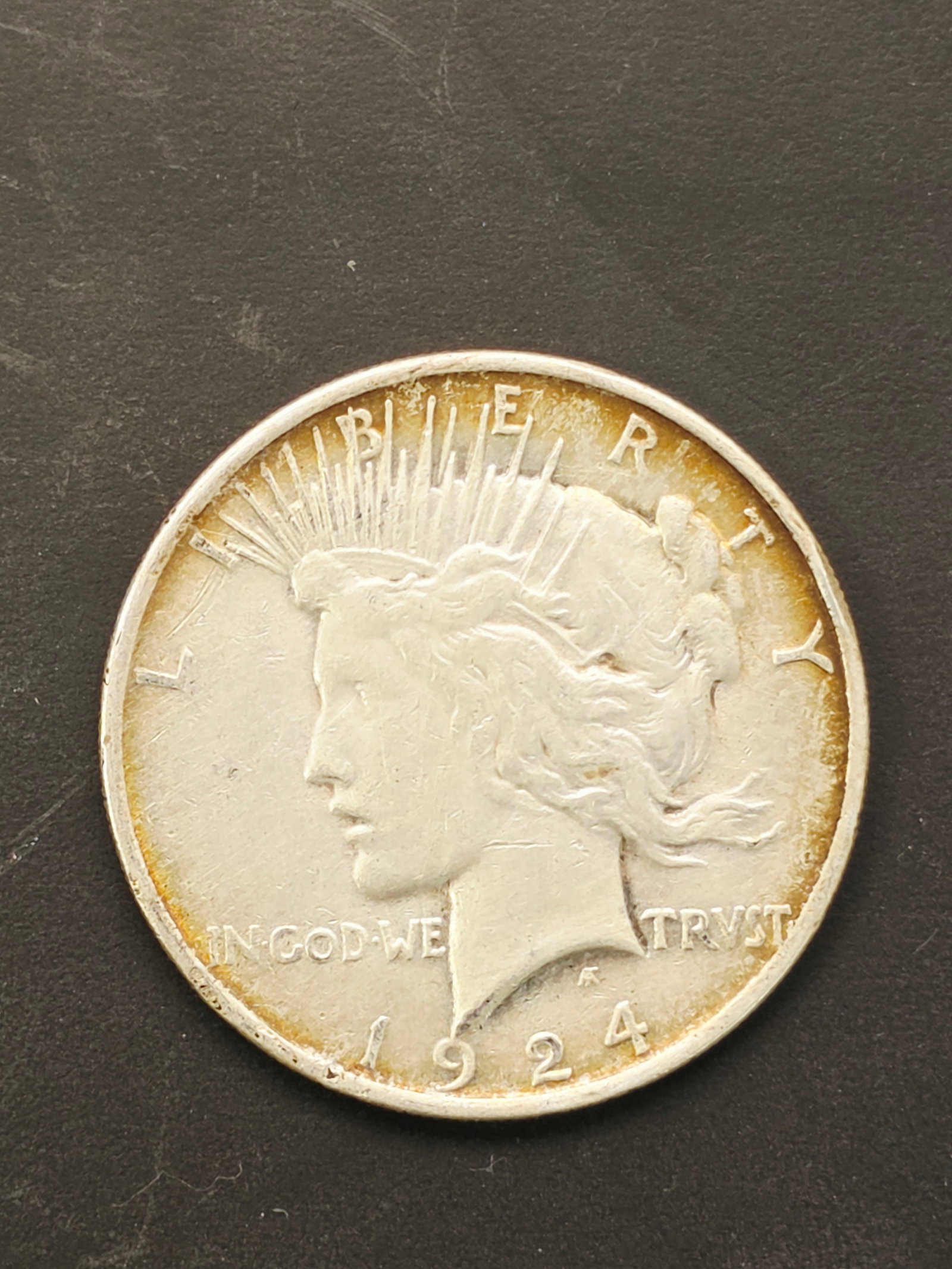 1924 Peace Silver Dollar: a 1924 Peace Silver Dollar.Acid tested for purity.Design Details: Designed by Anthony de Francisci, the obverse depicts the Goddess of Liberty, while the reverse (not shown) features a bald eagle