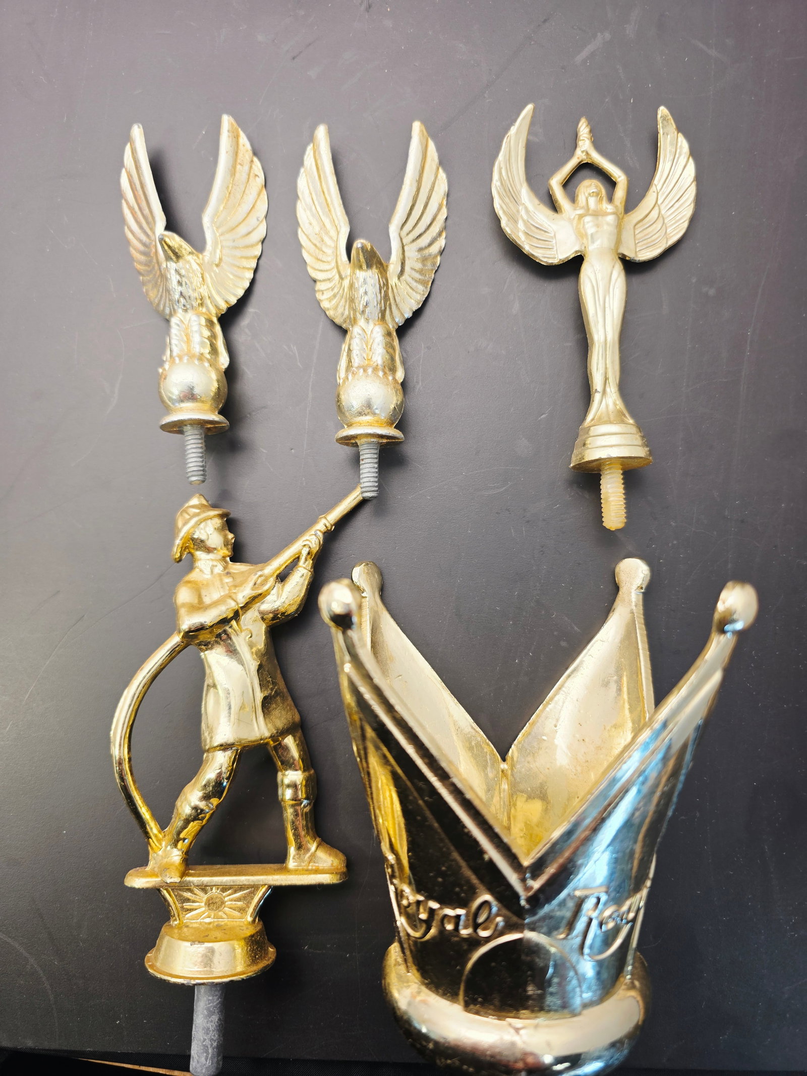 vintage metal trophy toppers and components.: vintage metal trophy toppers and components.Components: The items include gold-toned figures of eagles on globes, a victory goddess, a crowned crest or wreath, and a shooter or archer.Era: These
