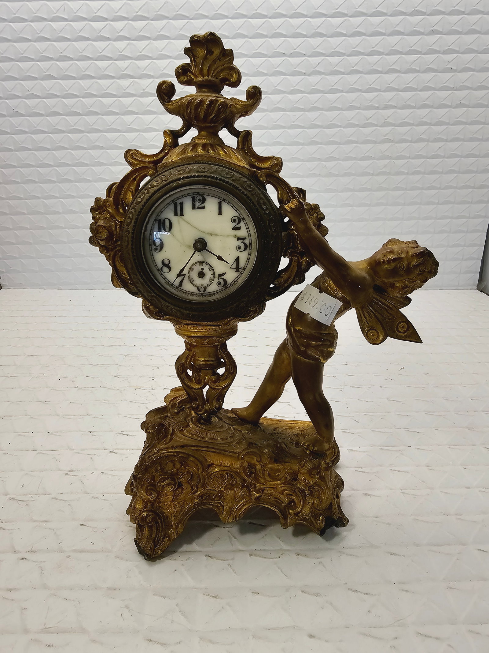 antique Art Nouveau gilt metal mantle clock: as is, untested, one leg is shorter, broken or bended.antique Art Nouveau or Victorian figural mantle clock made of cast metal with a gilt finish.Manufacturer: Similar clocks were produced by the New 