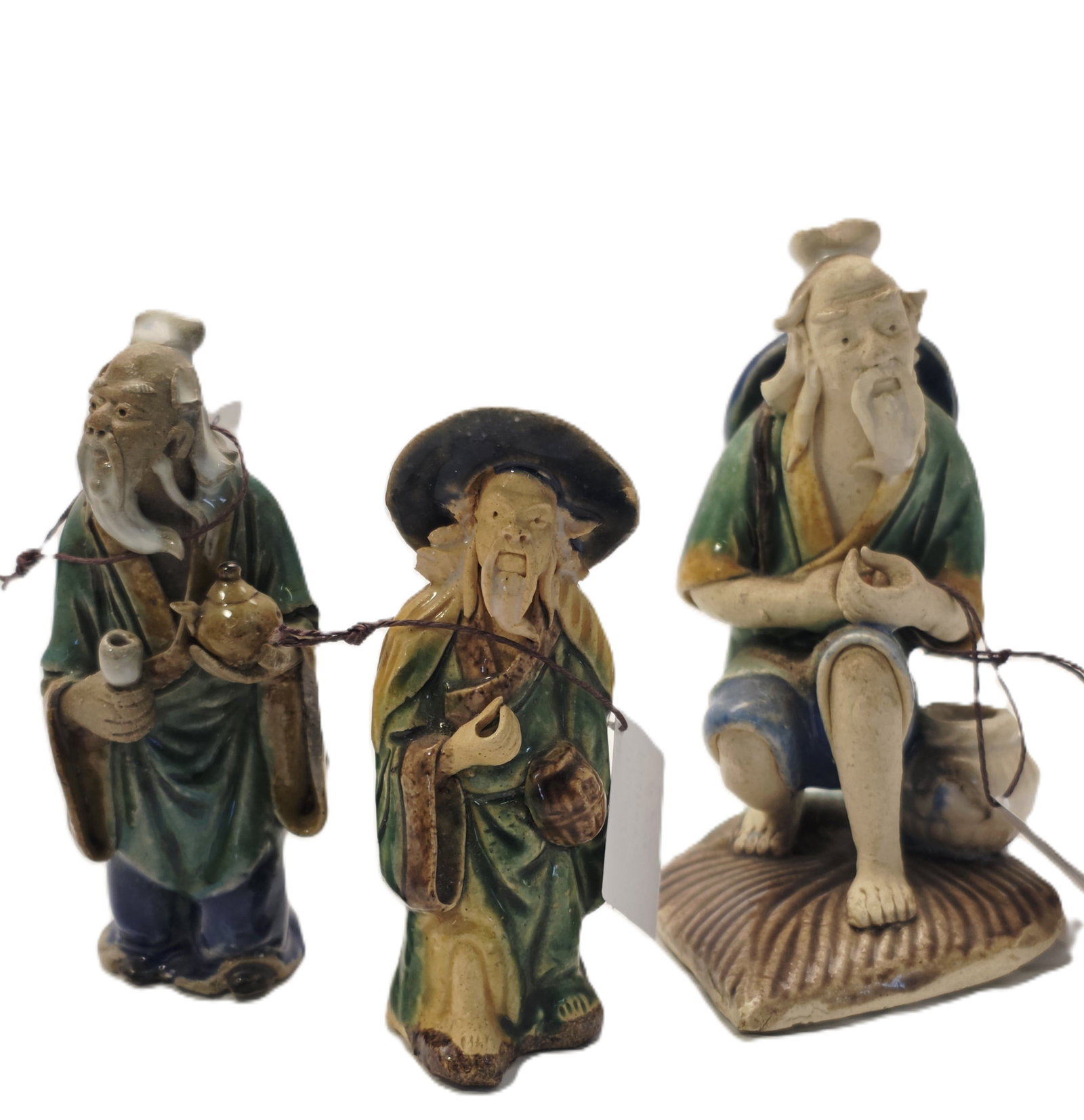 three Shiwan Pottery Mudman figurines: Shiwan pottery Mudman figure likely dating from the late 19th to early 20th century.Materials and Style: These figurines are hand-molded from clay and typically feature vibrant, low-temperature