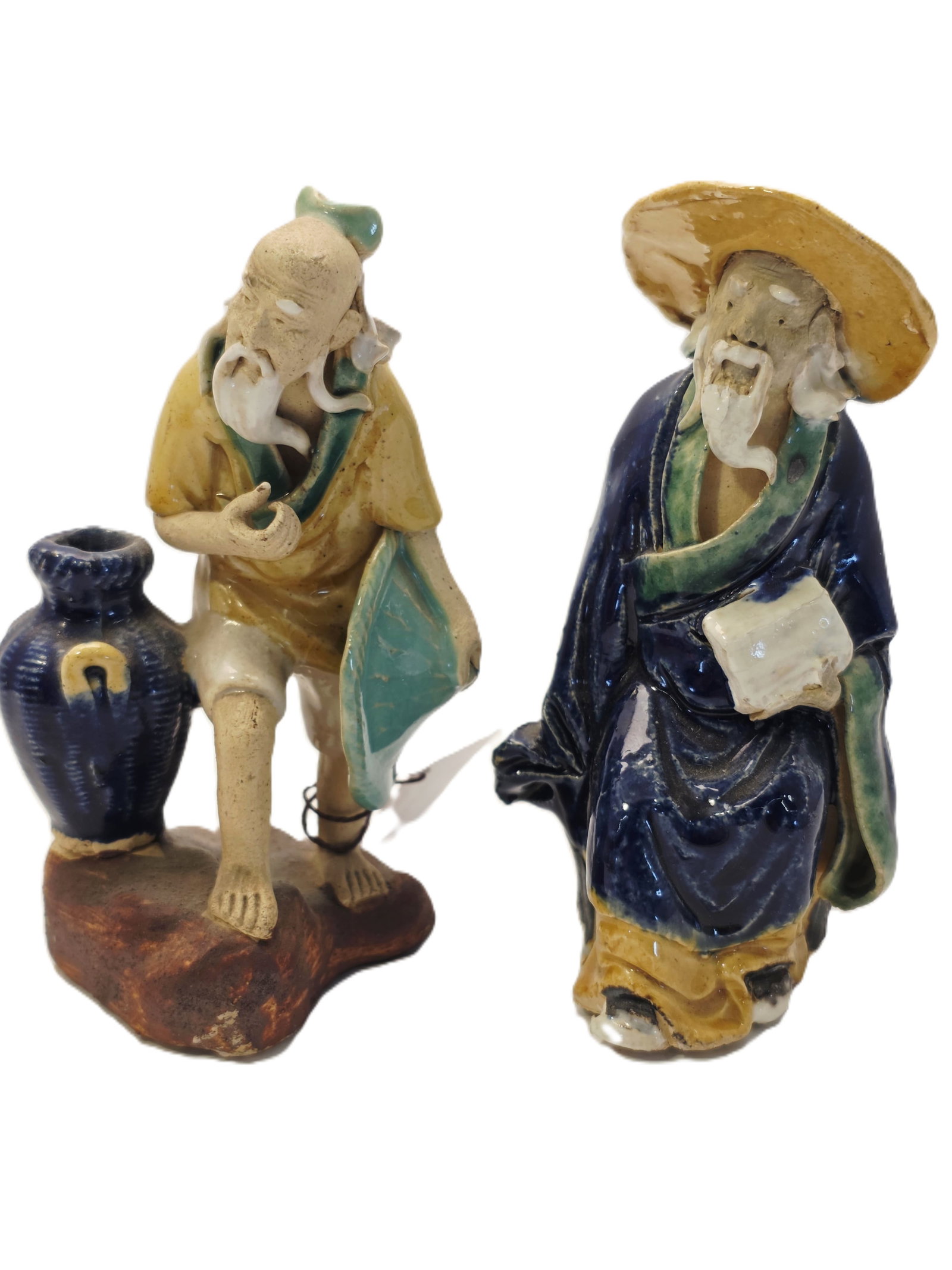 Two Shiwan Pottery Mudman Figurines: Shiwan pottery Mudman figure likely dating from the late 19th to early 20th century.Materials and Style: These figurines are hand-molded from clay and typically feature vibrant, low-temperature