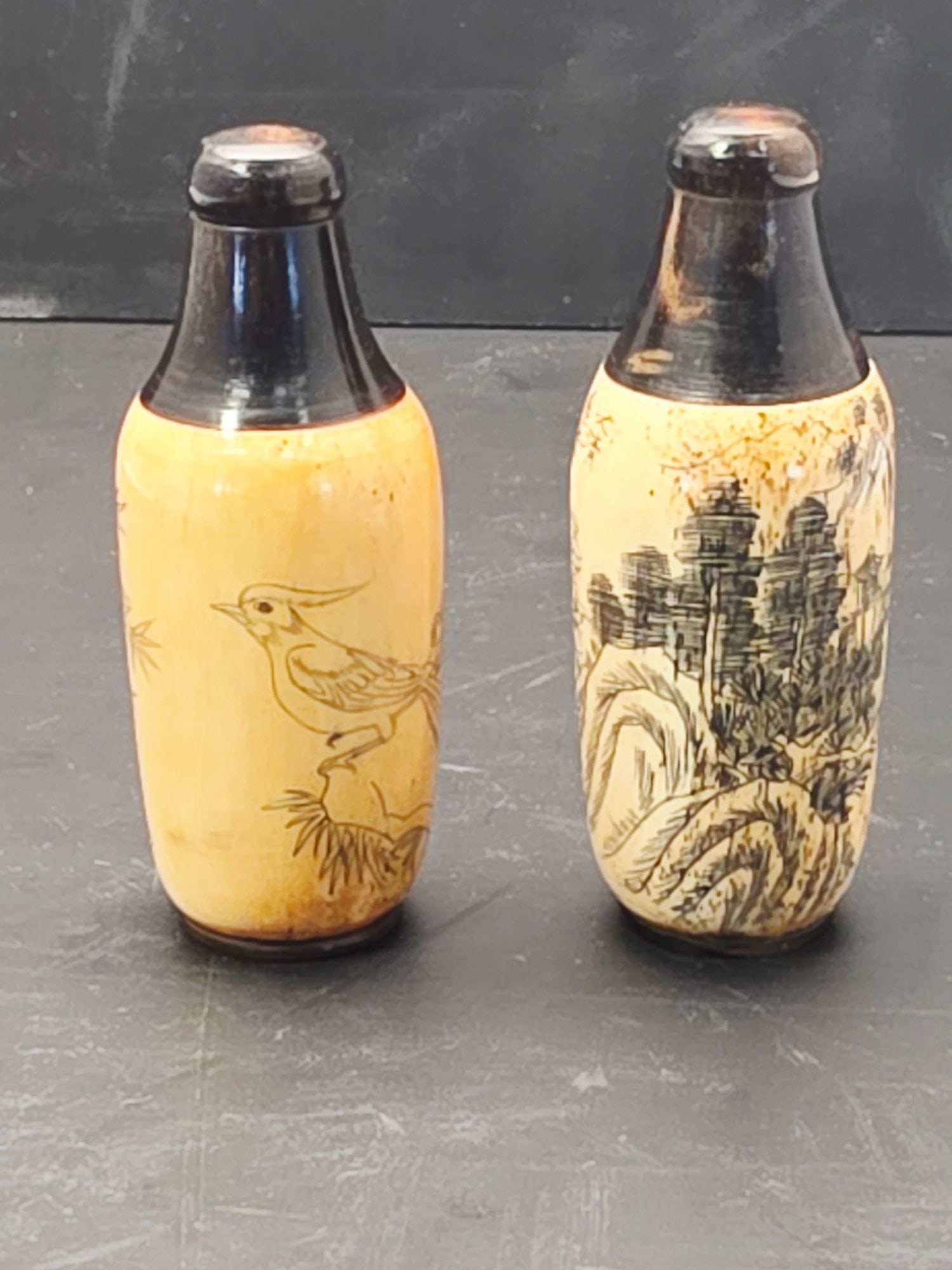 Antique Chinese carved bone etched snuff bottles: Antique Chinese carved bone etched snuff bottles, Chinese characters, landscape, signed Unsure how and if they open.Condition