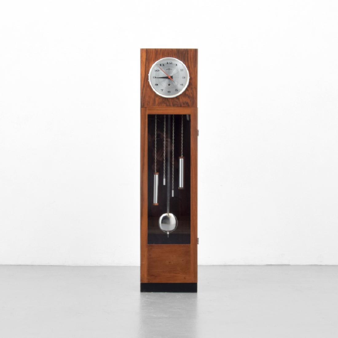 Howard Miller Rosewood Pendulum Floor Clock: Designer (Artist), Manufacture: Howard Miller Clock Company Markings: Howard Miller Clock Company mark Country of Origin, Materials: USA; rosewood, chromed and brushed metal, glass Additional Informat