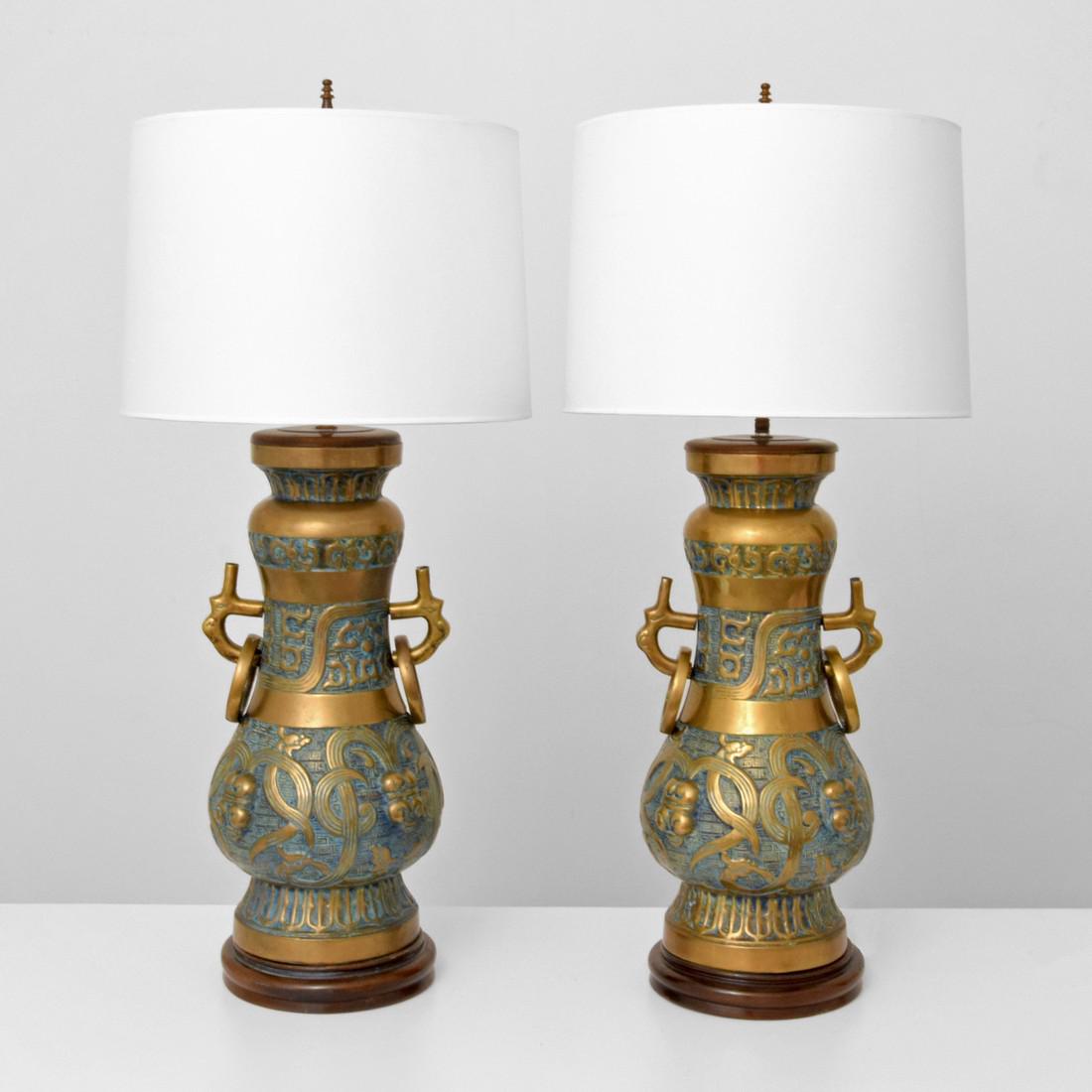 Pair of Monumental Pepe Mendoza Lamps: Designer & Manufacturer: Pepe Mendoza Markings: no marking(s) apparent Country of Origin & Materials: Mexico; bronze, ceramic, wood Additional Information: Lamps have two light sockets each. Dimension