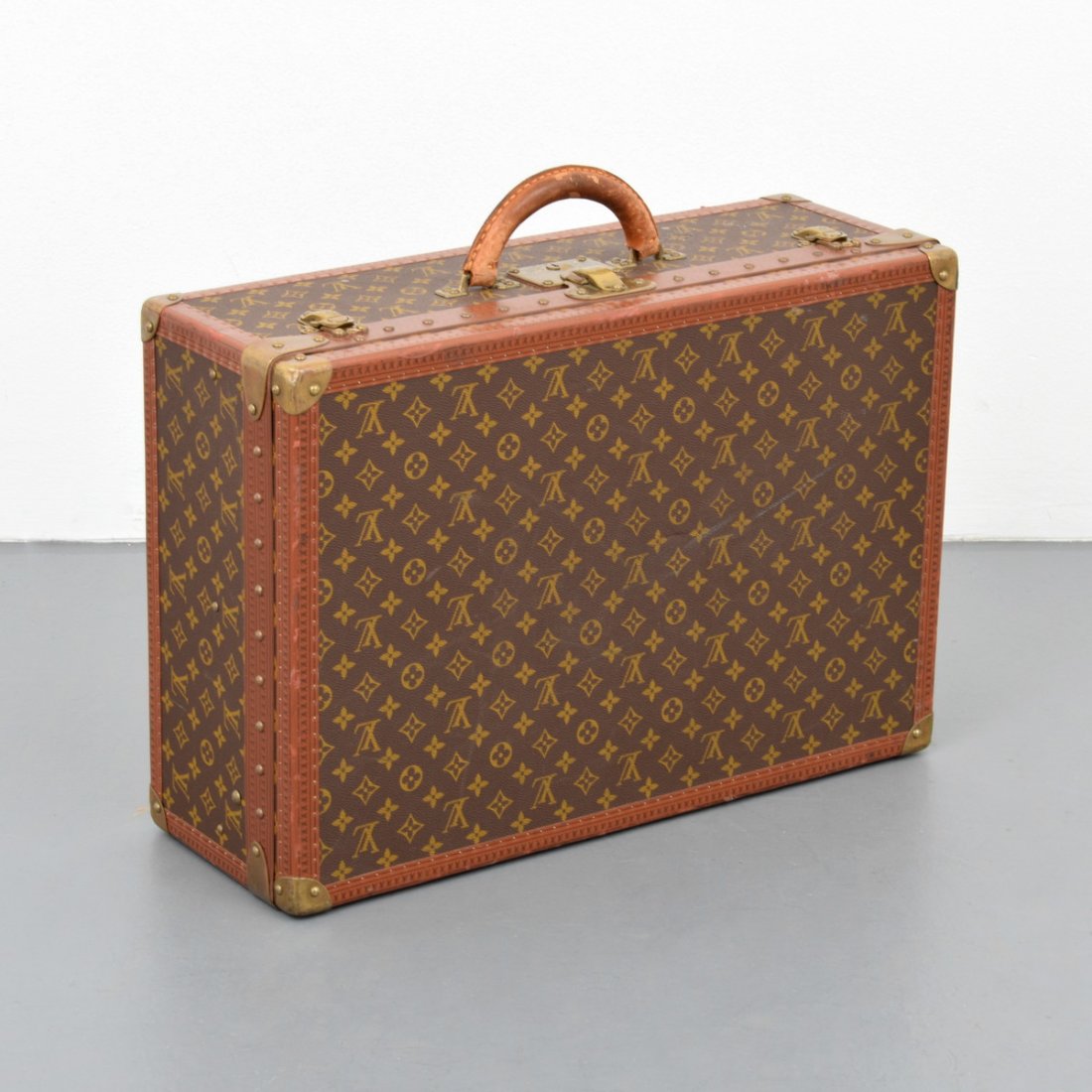 Louis Vuitton Monogrammed Suitcase: Designer/Artist & Manufacturer: Louis Vuitton Markings: brass hardware imprints including: Louis Vuitton, Made in France, logo, marking(s); inside markings include: Louis Vuitton print on straps Count