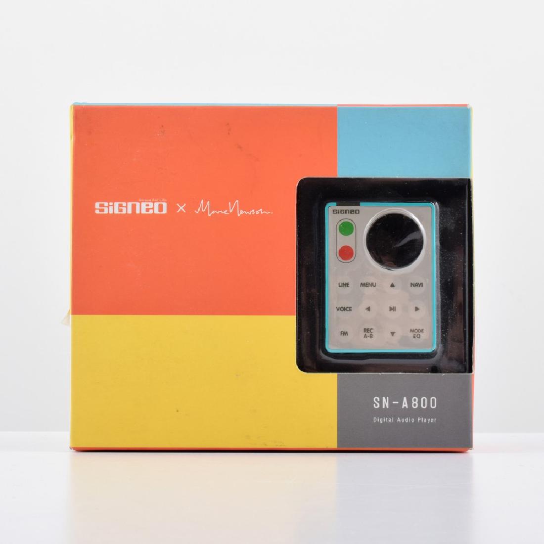 Signeo x Marc Newson Limited Release MP3 player: Designer/Artist; Manufacturer: Marc Newson; Signeo Markings: marking(s) Country of Origin & Materials: Japan; plastic, other Additional Information: Digital audio player is model SN-A800, released on