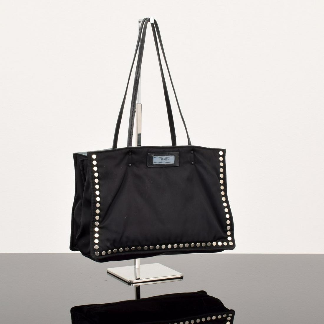 Prada Tessuto "Etiquette" Studded Tote Bag: Artist/Designer; Manufacturer: Prada Marking(s); notes: Prada plaque and imprint Country of origin; materials: Italy; tessuto, leather, metal Dimensions (H, W, D): 7.75"h, 1