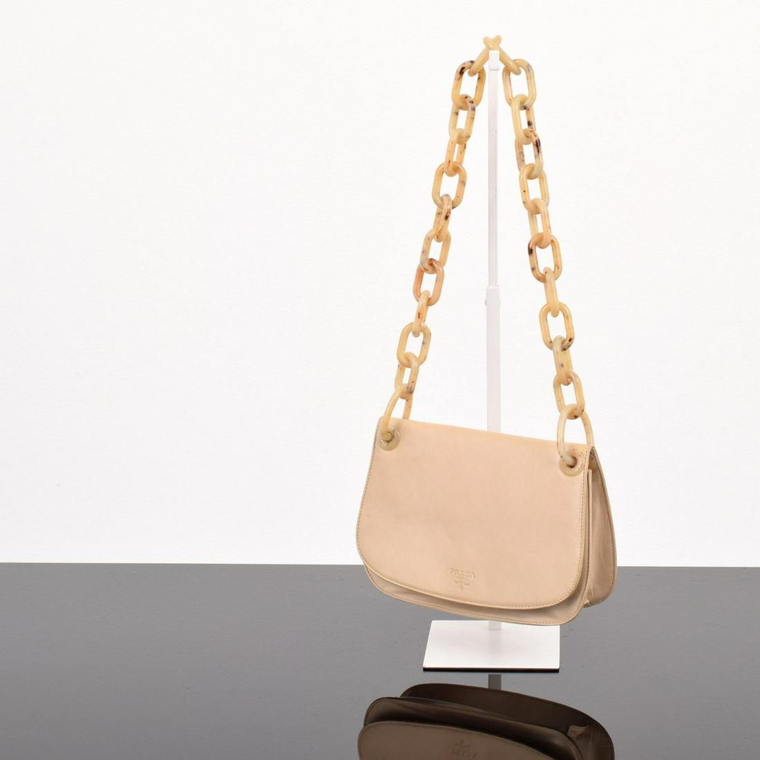 Prada Madras Swing Chain Link Shoulder Bag: Artist/Designer; Manufacturer: Prada Marking(s); notes: Prada imprint and plaque, logo lining Country of origin; materials: Italy; leather, resin, metal Dimensions (H, W, D): 6.25"h, 8.5"w, 1.75"d (No