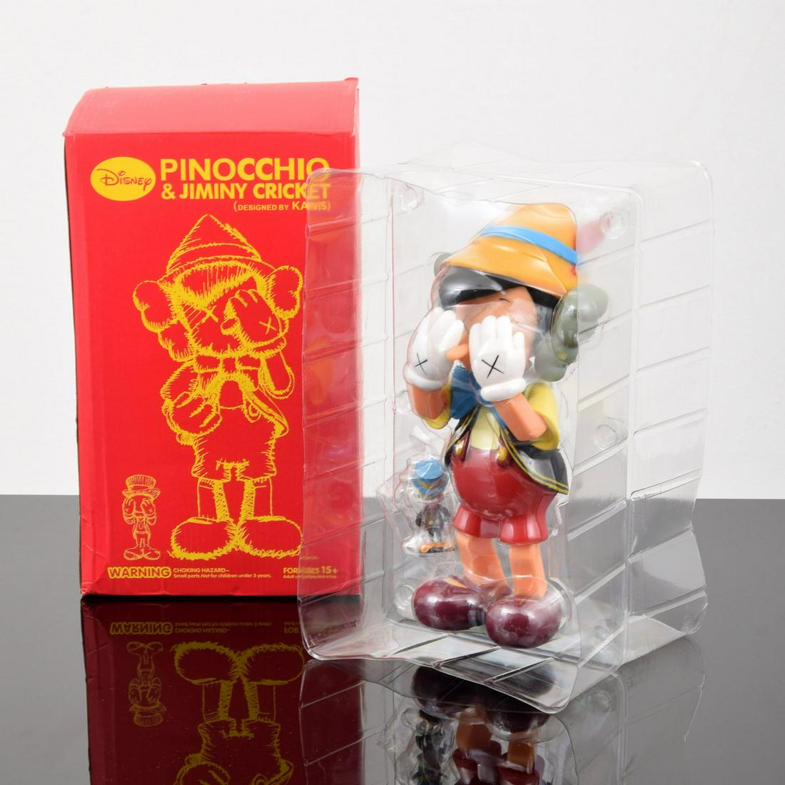 KAWS "Pinocchio & J. Cricket (KAWS Design/Disney),": Artist/Designer; Manufacturer: KAWS aka Brian Donnelly (b. 1974); Medicom Toy Corporation Marking(s); notes: marking(s); 2010 Country of origin; materials: American; painted cast vinyl Dimensions (H,