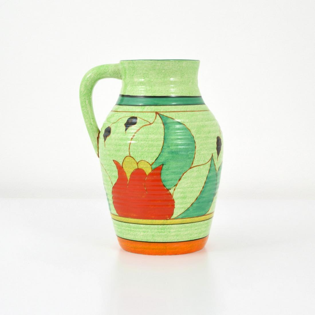 Large Clarice Cliff "Cafe Au Lait Tulip Lotus" Jug: Artist/Designer; Manufacturer: Clarice Cliff (1899-1972) Marking(s); notes: signed, marking(s) Country of origin; materials: English; hand-painted ceramic Dimensions (H, W, D): 11.75"h, 9"w, 8"d Addit