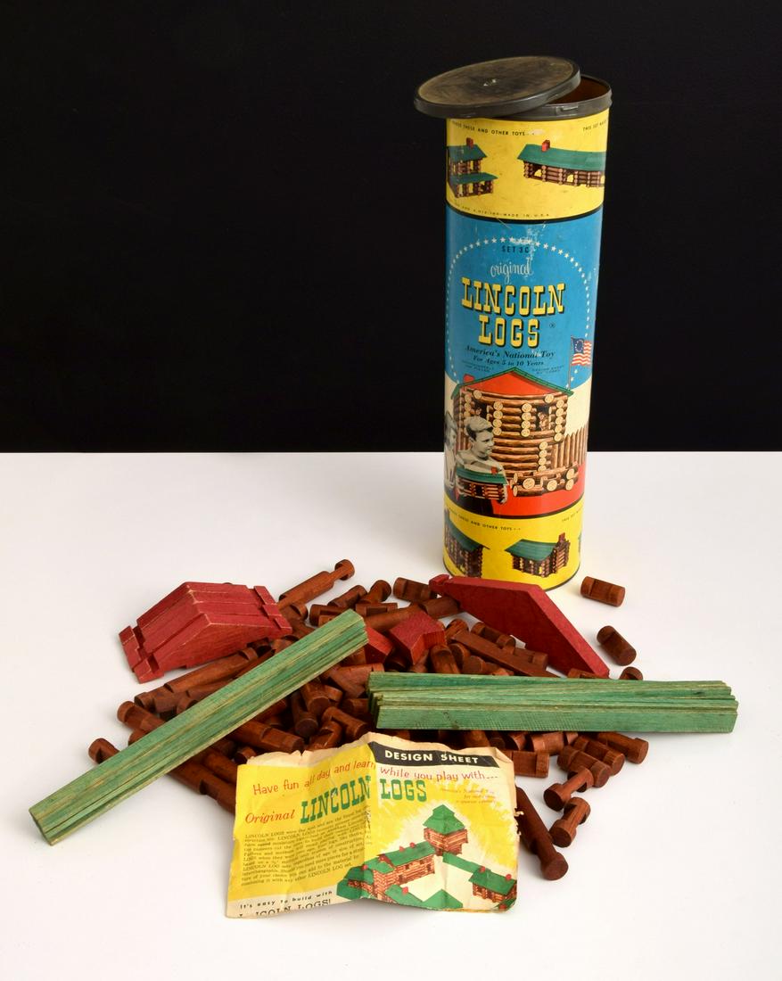 Vintage Lincoln Logs Toy: Artist/Designer; Manufacturer: Lincoln Logs Co. Marking(s); notes: marking(s) Country of origin; materials: USA; wood, metal, paper Dimensions (H, W, D): container: 18"h, 5.5"dia Additional Informatio
