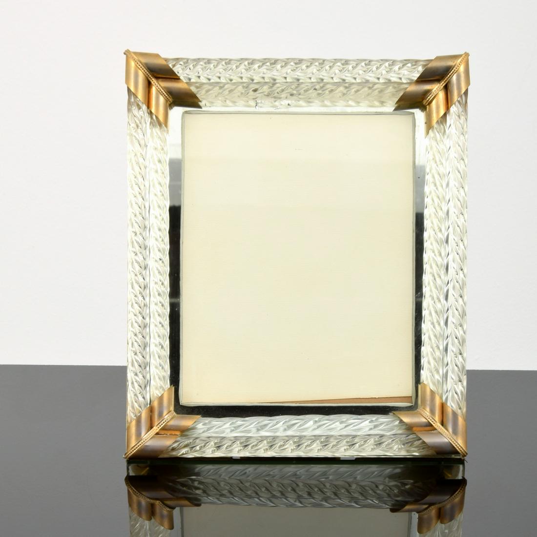"Cordonato" Table Mirror Attributed to Venini: Artist/Designer; Manufacturer: Venini, attributed Marking(s); notes: no marking(s) apparent Country of origin; materials: Italy; glass, brass, fabric Dimensions (H, W, D): 13"h, 11"w Additional Inform