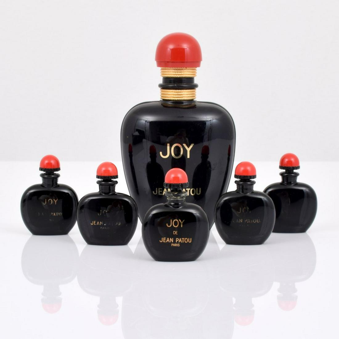 6 Jean Patou "Joy" Perfume Bottles: Artist/Designer; Manufacturer: Jean Patou Marking(s); notes: signed, labels, marking(s) Country of origin; materials: France; glass, plastic Dimensions (H, W, D): largest: 5.75"h, 3.5"w, 1.5"d Additio