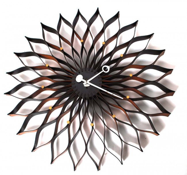 George Nelson Sunflower Clock: Designer & Manufacturer: George Nelson; Howard Miller Clock Co. Markings: label Country of Origin & Materials: USA; walnut, wood, metal Additional Information & Circa: Large and early "sunflower" wall