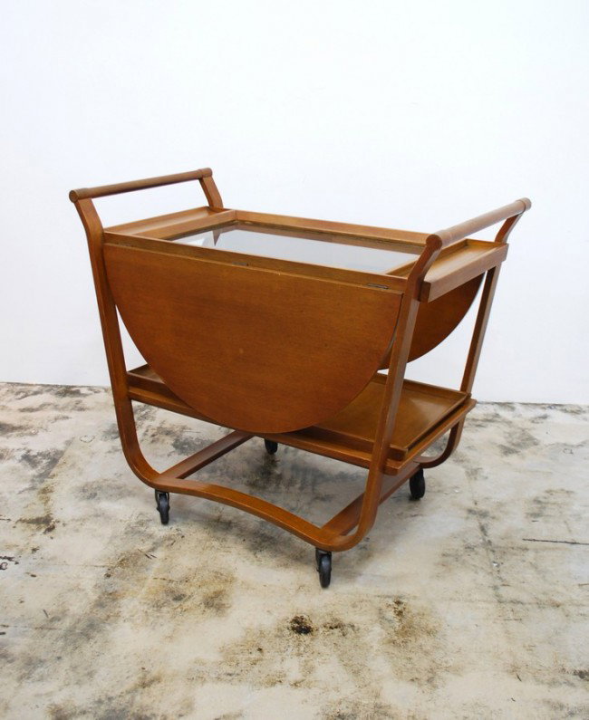 Early Edward Wormley Tea Cart: Designer & Manufacturer: Edward Wormley; Dunbar Markings: green metal tag Country of Origin & Materials: USA; wood, glass Additional Information & Circa: Rare and early tea cart on wheels with 2 remov