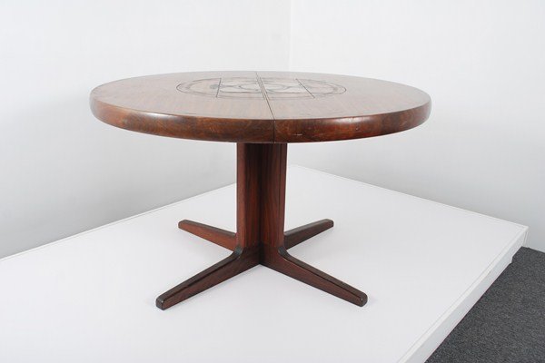Rosewood Dining Table, 2 Leaves: Designer & Manufacturer: John Mortensen, Manner of Markings: marked Country of Origin & Materials: Denmark; rosewood, pottery Additional Information & Circa: Rosewood dining table with decorative pott