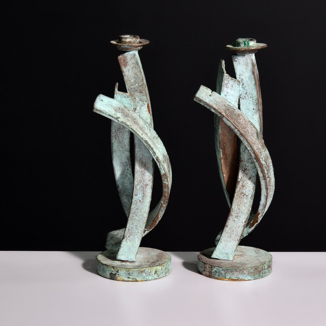 Pair of Joseph Wesner Candlesticks: Artist/Designer; Manufacturer: Joseph Wesner (American, 1955-2002) Marking(s); notes: signed, c 1990; 1990 Materials: patinated metal Dimensions (H, W, D): 13"h, 6.25"w, 4.25"d Additional Information: