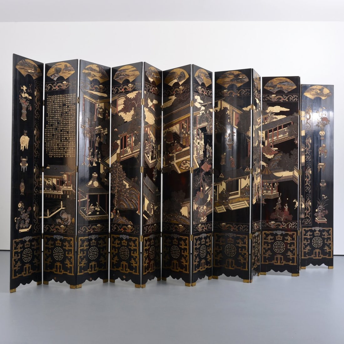 Chinese Coromandel 12-Panel Screen: Artist/Designer; Manufacturer: unknown Marking(s); notes: made in Hong Kong label Materials: carved and polychromed ebony, lacquer Dimensions (H, W, D): 96"h, 208"w outstretched Additional Information