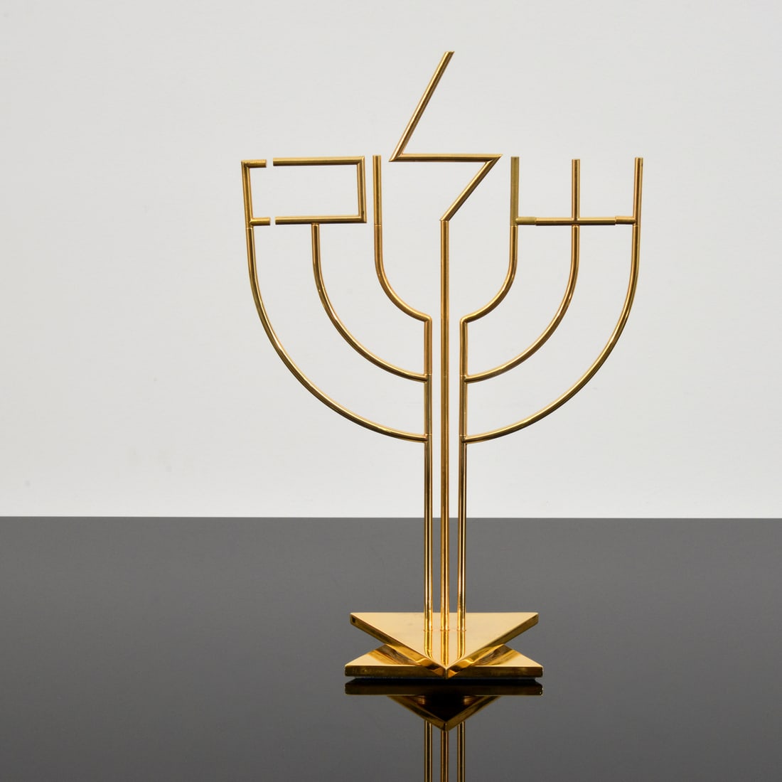 Yaacov Agam Kinetic Menorah Sculpture: Artist/Designer; Manufacturer: Yaacov Agam (Israeli, b. 1928) Marking(s); notes: signed, marking(s); H.C. 8/9 Materials: gold-plated metal Dimensions (H, W, D): 17.5"h, 11.25"w, 5"d; 19.25"h, 14.25"w,