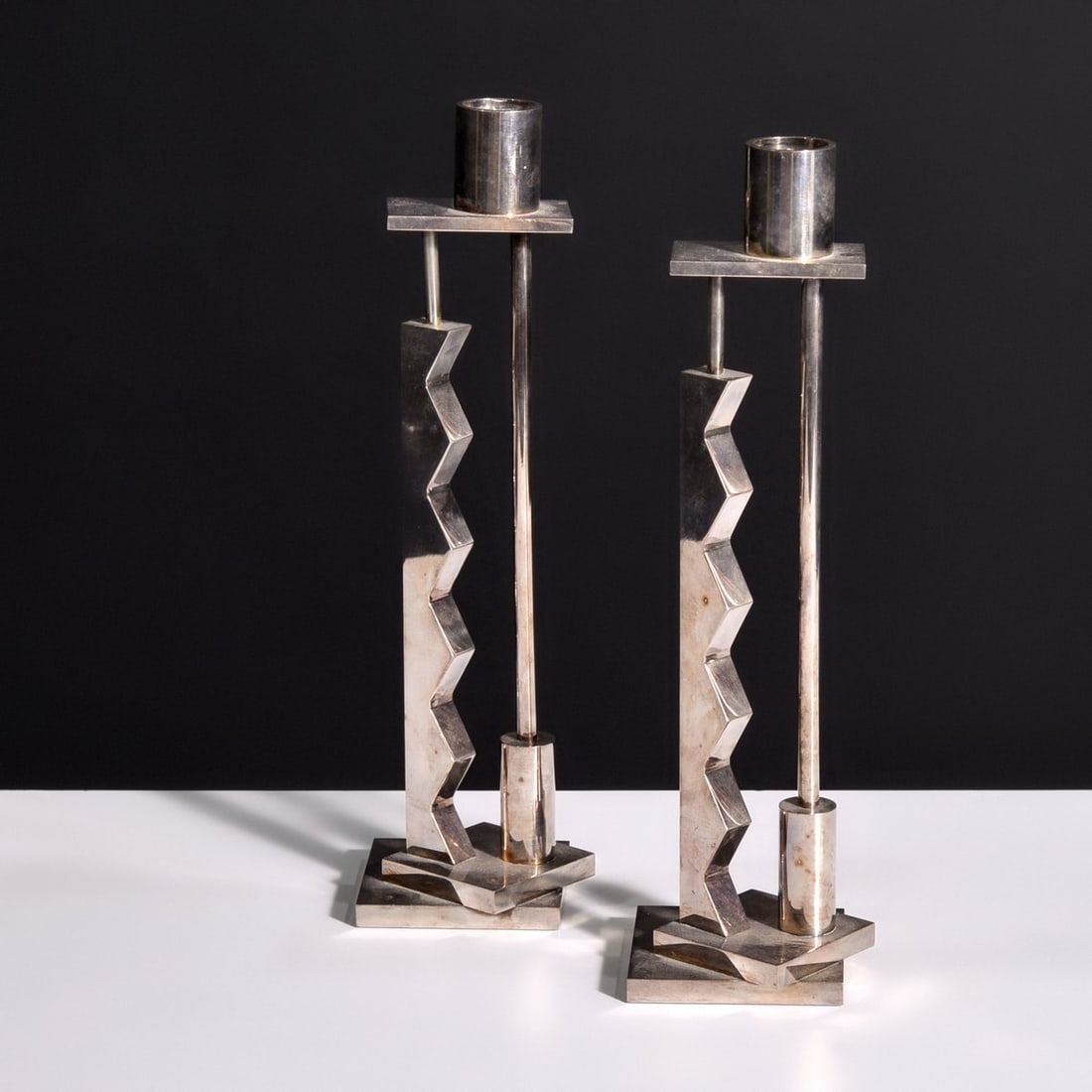 Pair of Ettore Sottsass ZIG ZAG Candlesticks: Artist/Designer; Manufacturer: Ettore Sottsass (Italian, 1917-2007); Swid Powell (USA) Marking(s); notes: signed, marking(s) Materials: silverplate Dimensions (H, W, D): 12.625"h, 3.75"w, 3.75"d Addit