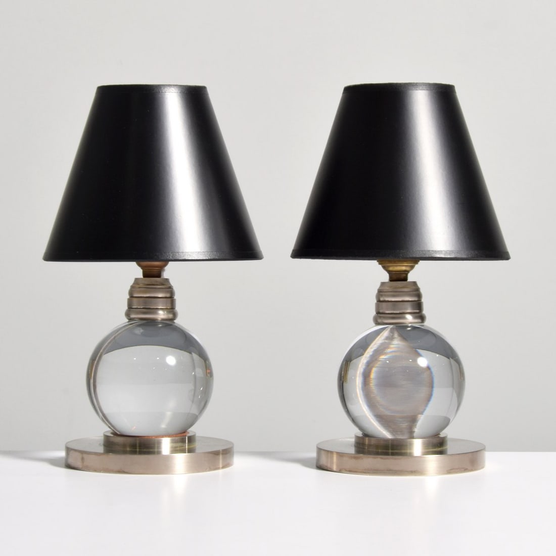 Pair of Jacques Adnet Lamps: Artist/Designer; Manufacturer: Jacques Adnet (French, 1900-1984); Baccarat (France) Marking(s); notes: no marking(s) apparent Materials: crystal, nickel-plated brass Dimensions (H, W, D): 7"h, 4.75"di