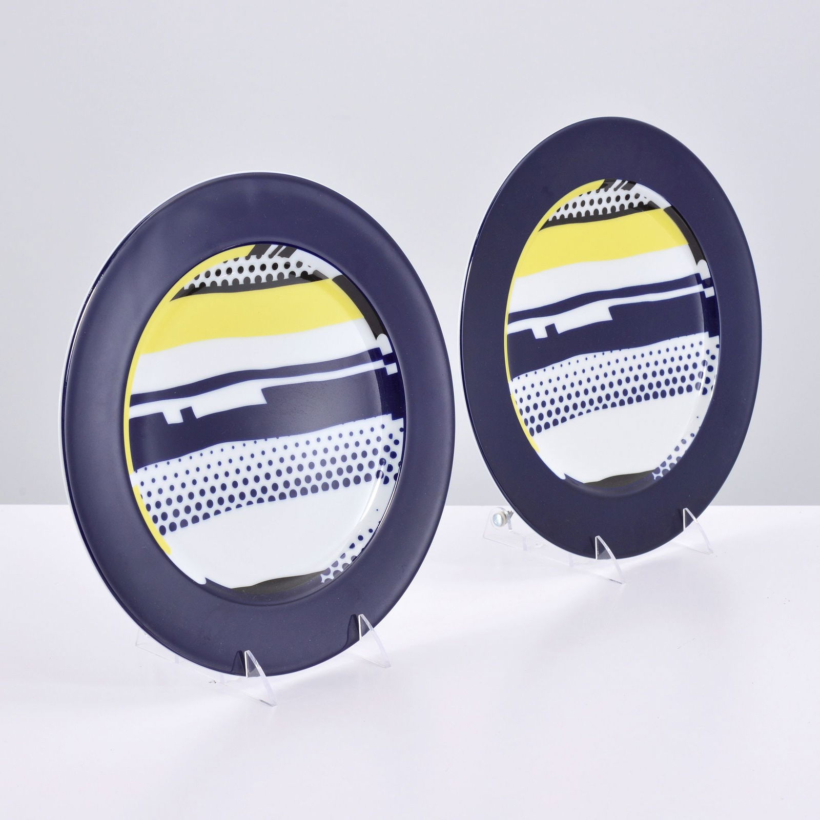 2 Roy Lichtenstein Display Plates, Limited Editions: Artist/Designer; Manufacturer: Roy Lichtenstein (American, 1923-1997); Rosenthal (Germany)Marking(s); notes: signed, marking(s); ed. 3000/0976, ed. 3000/1625 (see detailed photos)Materials