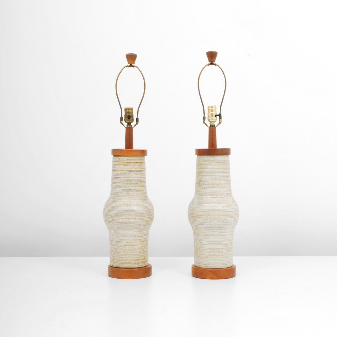 Pair of Gordon & Jane Martz Lamps: Designer & Manufacturer: Gordon & Jane Martz; Marshall Studios, Inc. Markings: marked Country of Origin & Materials: USA; wood, ceramic Additional Information & Circa: Pair of modern lamps by Gordon &