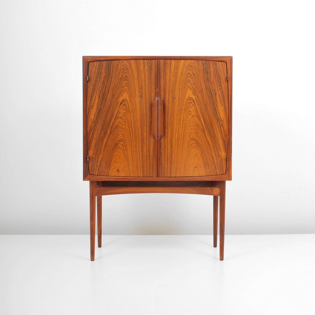 Torbjorn Afdal Rosewood Bar: Designer & Manufacturer: Torbjorn Afdal; Bruksbo Markings: marked Country of Origin & Materials: Norway; rosewood, glass, metal, mirror Additional Information & Circa: Fine rosewood bar with 2 doors r