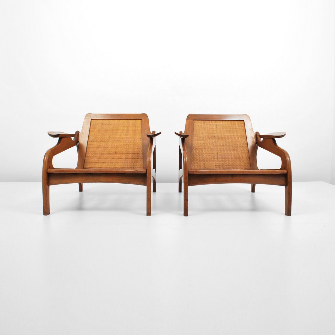 Adrian Pearsall, Pair of Lounge Chairs: Designer & Manufacturer: Adrian Pearsall; Craft Associates Markings: none Country of Origin & Materials: USA; walnut, caning Additional Information & Circa: Pair of lounge chairs by Adrian Pearsall c.