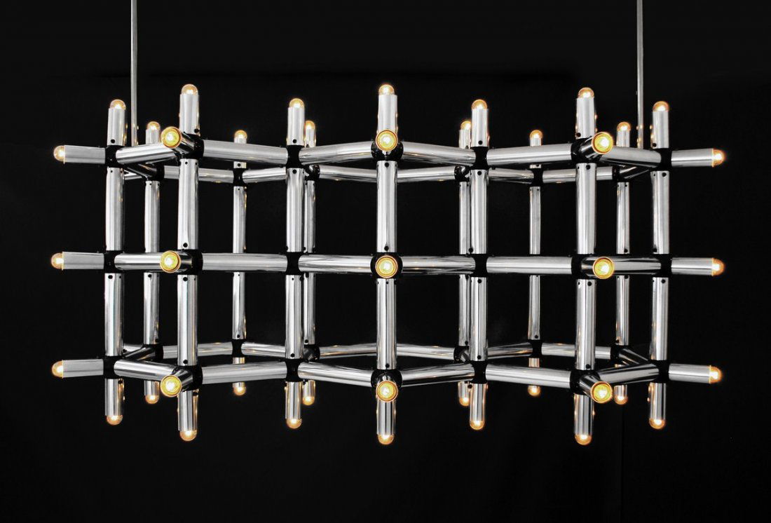Massive Robert Haussmann Chandelier: Designer & Manufacturer: Robert Haussmann; Swiss Lamp International Markings: none Country of Origin & Materials: Switzerland; chromed metal, other Additional Information & Circa: Massive atom chandel