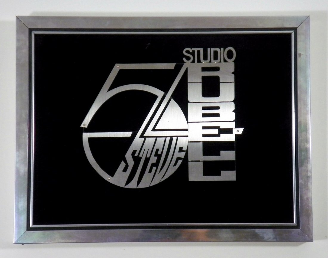 Custom Studio 54 Wall Plaque: Additional Information & Circa: Custom made wall plaque in velvet and polished chrome laminate of the Studio 54 logo and Steve Rubell's name. Provenance: Estate of Steve Rubell Dimensions: 10"h, 13"w