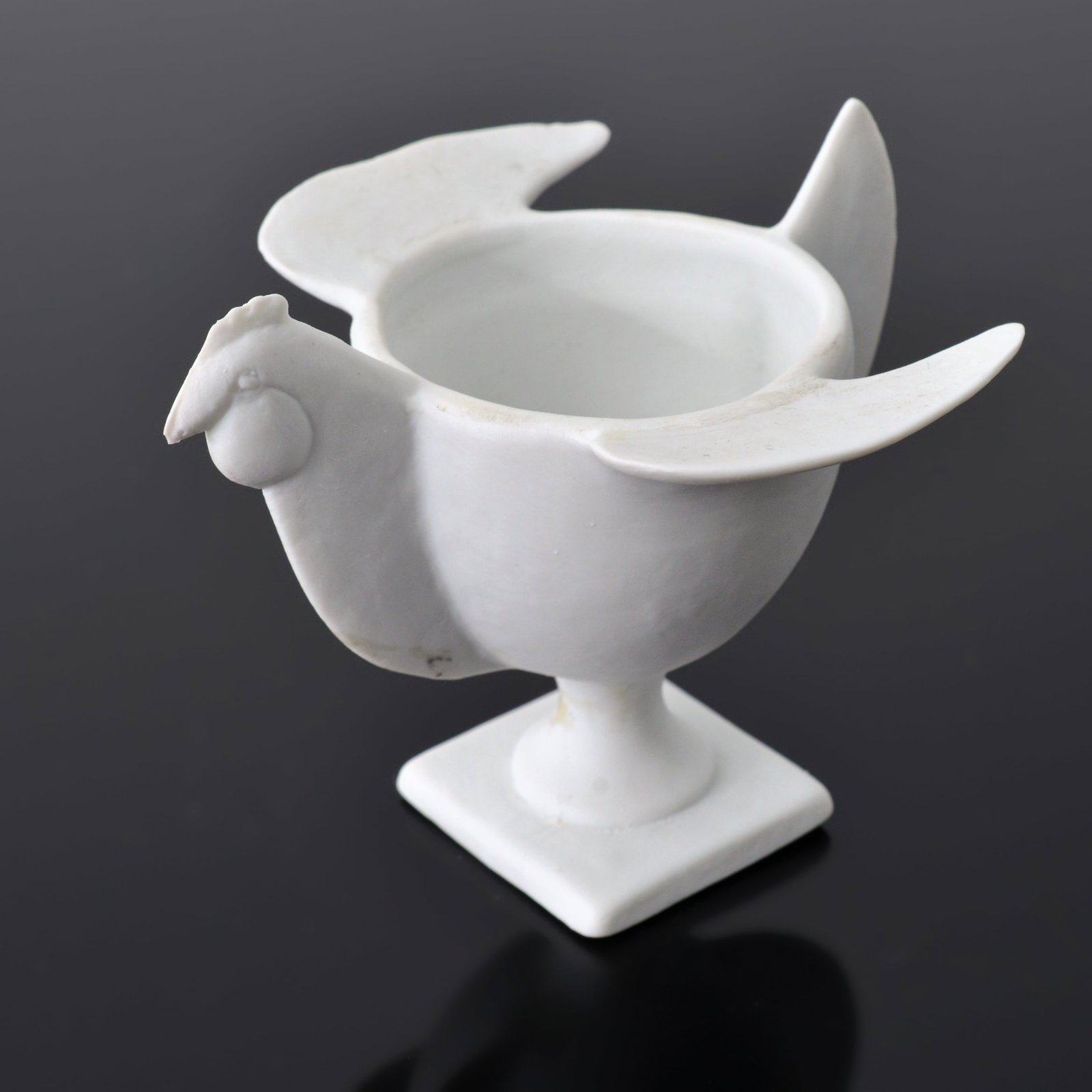 Francois-Xavier Lalanne COQUETIER POULE Egg Cup: Artist/Designer; Manufacturer: Francois-Xavier Lalanne (French, 1927-2008); Artoria Limoges (France)Marking(s); notes: signed, marking(s)Materials: porcelainDimensions (H