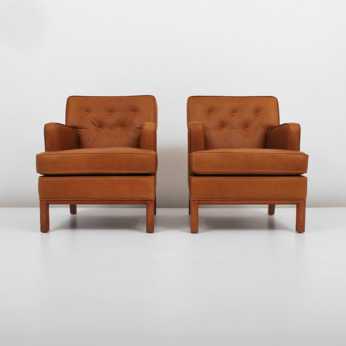 Pair of Edward Wormley Lounge Chairs: Designer & Manufacturer: Edward Wormley; Dunbar Markings: none Country of Origin & Materials: USA; leather, wood Additional Information & Circa: Pair of leather lounge chairs by Edward Wormley; c. 195